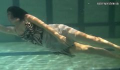 Dressed up teen Irina Barna swims sexy in the pool