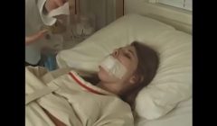 Pretty brunette in Straitjacket taped mouth tied to bed hospital