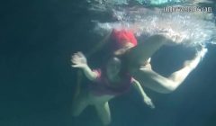 Two hot lesbians underwater touching each-other. y. s are naked in the pool. Young nudists ..
